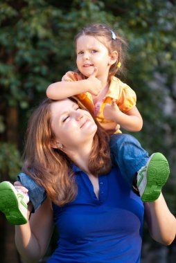 Little Girl on Mother's Shoulders clipart