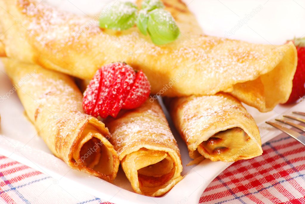 Rolled pancakes with icing sugar