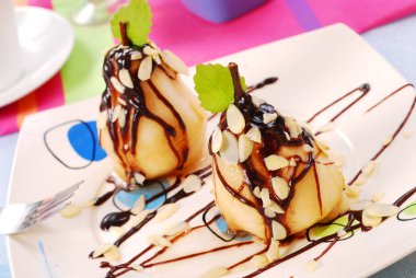 Pears with flaked almonds and chocolate clipart