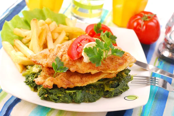 Fish on spinach with fries — Stock Photo, Image