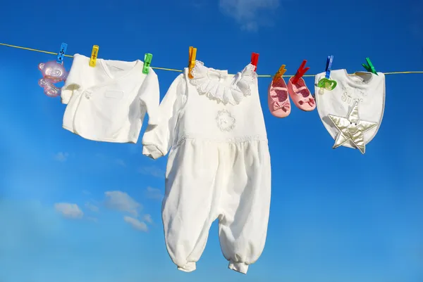 Baby clothes on clothesline — Stock Photo, Image