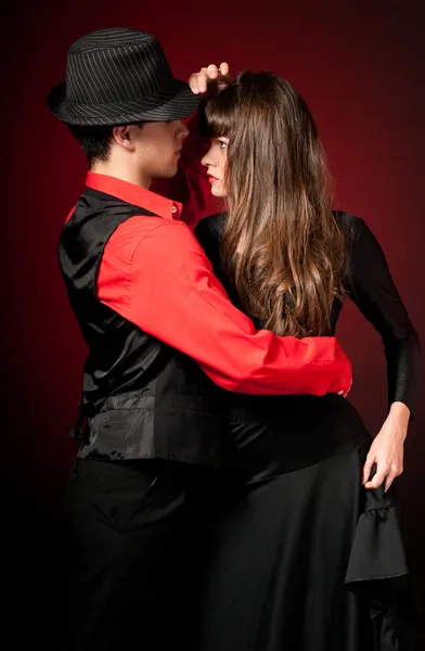 Giovane coppia passione danza su rosso luce backgr — Foto Stock