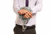 Businessman hands fettered with chain and padlock, job slave symbol, isolat