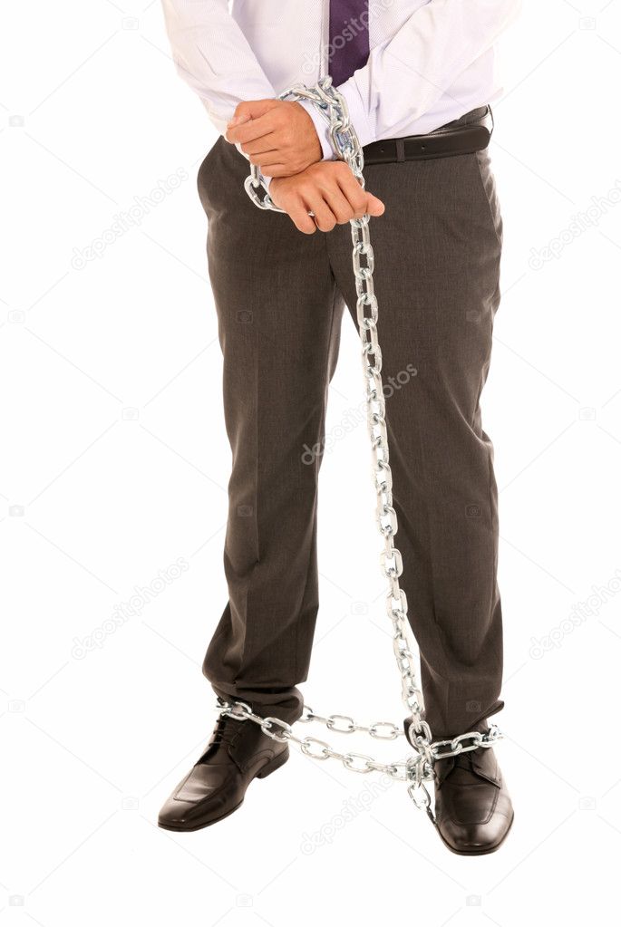 Businessman hands and legs fettered with chain, job slave symbol, isolated