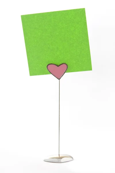Green notes on heart shape holder — Stock Photo, Image