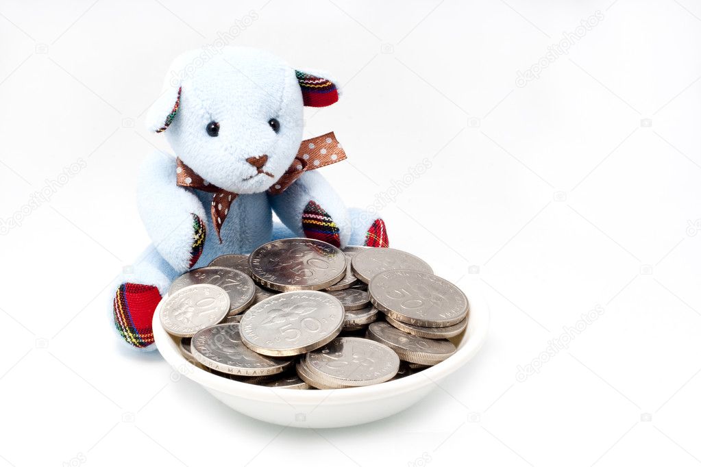 Bear guarding coins with an isolated whi