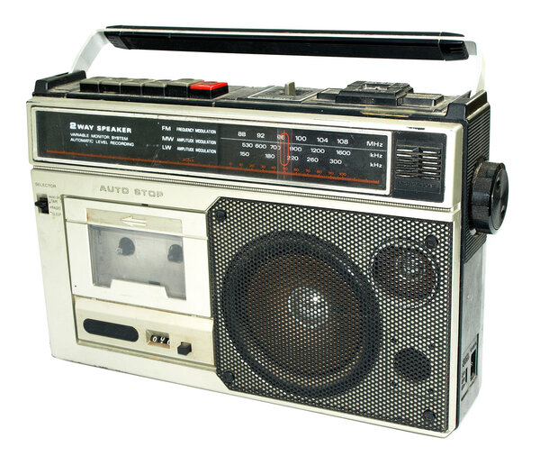 Dirty old 1980s style cassette player radio against a white background