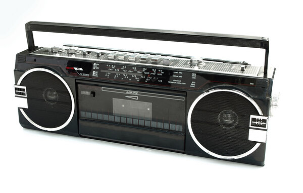 Dirty old 1980s style cassette player radio against a white background