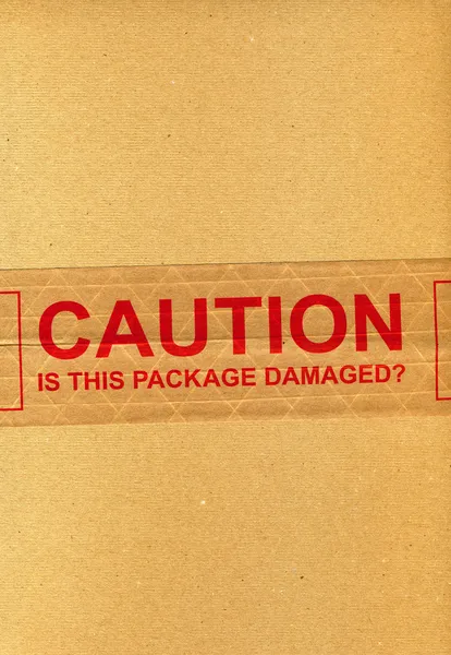 CAUTION is this package damaged? — Stock Photo, Image