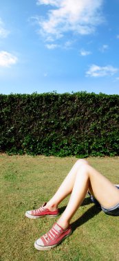 Relaxed girl lying down in a field on a clipart