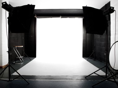 Empty studio with lights and white backg clipart