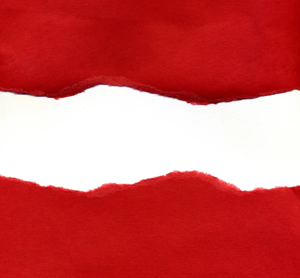 Papel rasgado vermelho revelando um backgro branco — Fotografia de Stock