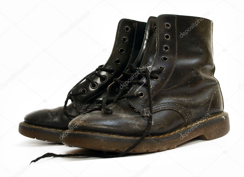 A pair of old black worn out work boots