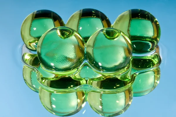 Green spheres in water — Stock Photo, Image