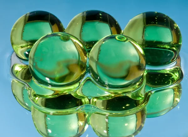 Green spheres in water — Stock Photo, Image