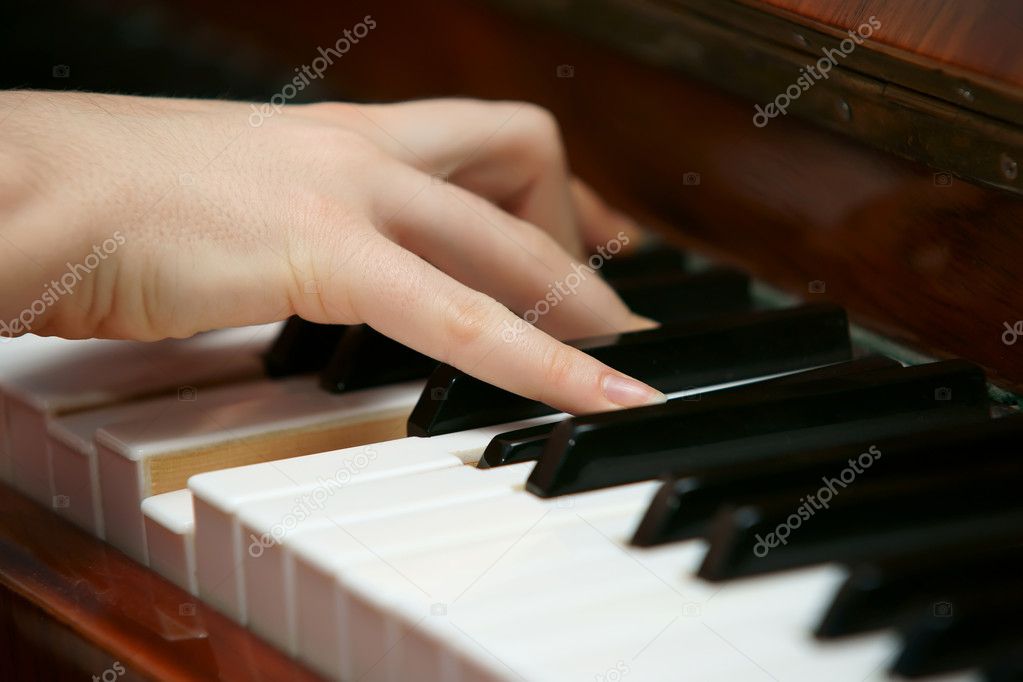 Hands playing music on the piano