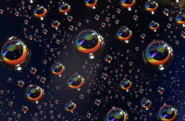 Laser disk in reflexion of drops — Stock Photo, Image