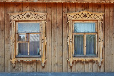 Two wood ornate windows in russian old style clipart