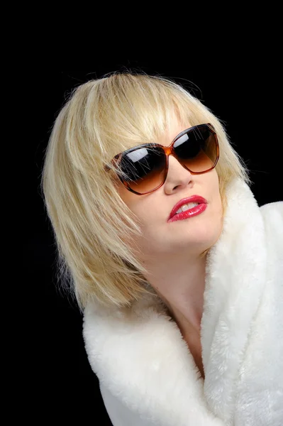 Blond girl with fur coat and sunglasses Royalty Free Stock Photos