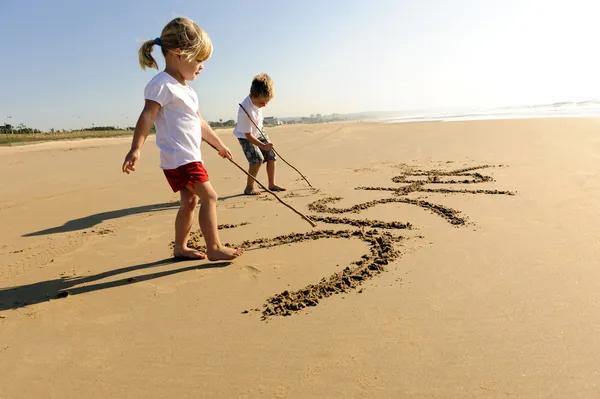 Kids writing in sand — Stock Photo, Image