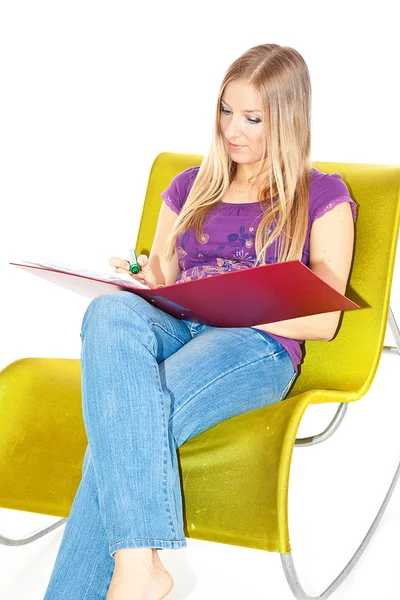 Woman on chair taking notes — Stock Photo, Image