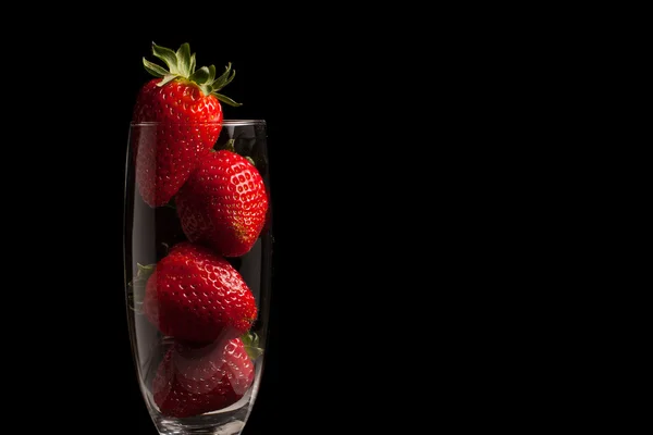 stock image Strawberries in a glass on black