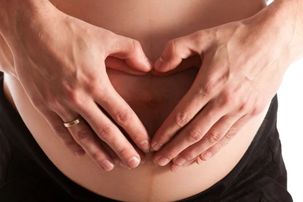 Barriga grávida avançada com as mãos — Fotografia de Stock