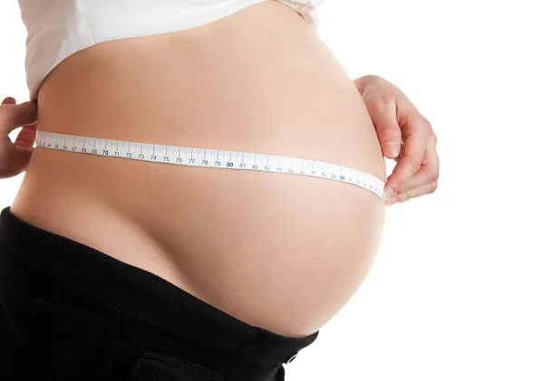 Advanced pregnant belly with hands — Stock Photo, Image