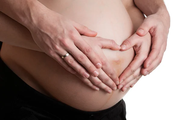 Avancerade gravid mage med händerna — Stockfoto