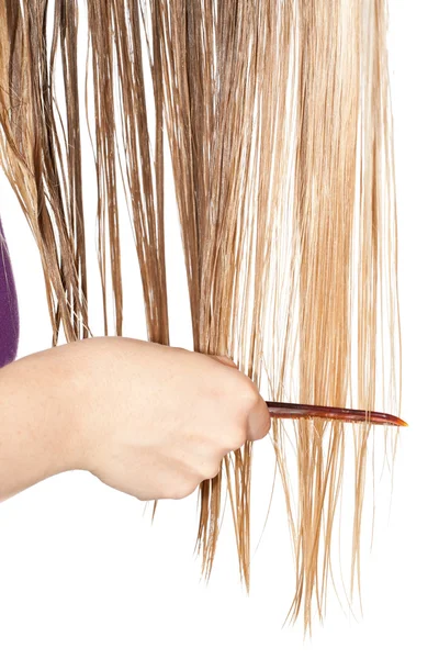 Woman combing hair — Stock Photo, Image