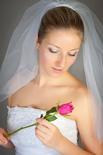 stock image Bride posing in wedding dress and rose