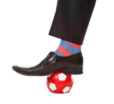 Man leg in suit with soccer ball and stripped socks clipart