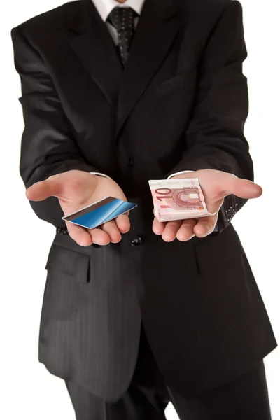 Biznesmen posiadania pieniędzy i karty kredytowej na biały na białym tle bac — Zdjęcie stockowe