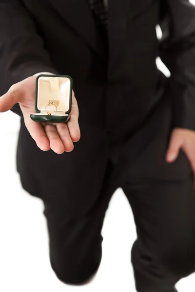 Człowiek w garniturze gospodarstwa pierścionek zaręczynowy na na białym tle — Zdjęcie stockowe