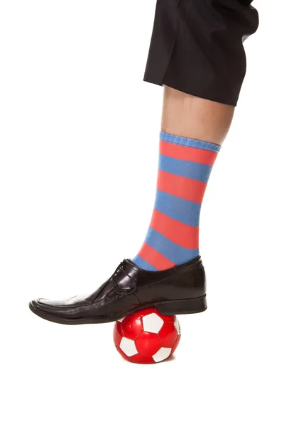 Man leg in suit with soccer ball and stripped socks — Stock Photo, Image