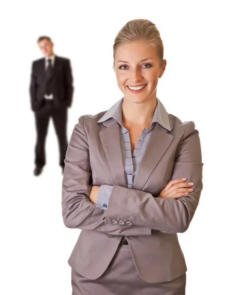 Geschäftsfrau mit Geschäftsmann im Hintergrund — Stockfoto