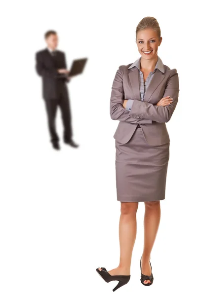 Business woman with businessman in background — Stock Photo, Image