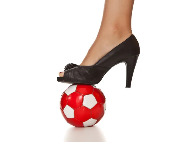 Caucasian blond business woman leg in high heel with soccer ball — Stockfoto