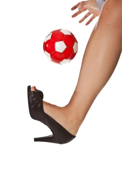 Caucasian blond business woman leg in high heel with soccer ball — Stok fotoğraf