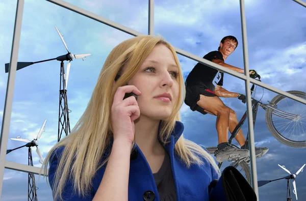 Business lady with cell phone on office against windgenerators a