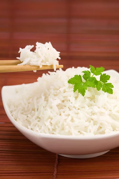 Bowl of rice on mat — Stock Photo, Image