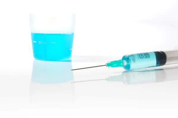 Syringe with blue liquid — Stock Photo, Image