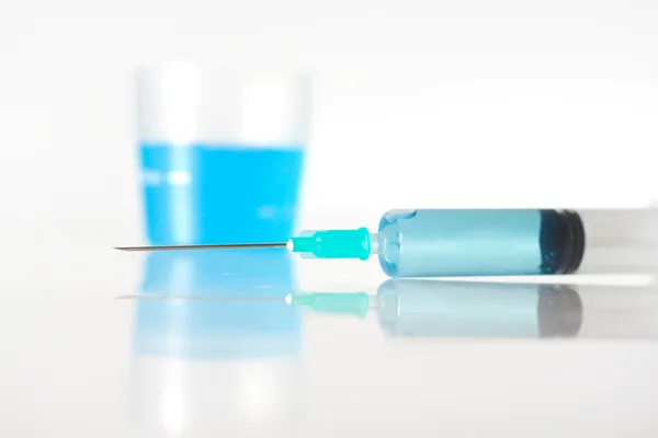 Syringe with blue liquid — Stock Photo, Image