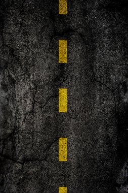 Asphalt background texture with a divided yellow line clipart