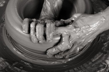 Close-up picture of a potter works a potter's wheel clipart