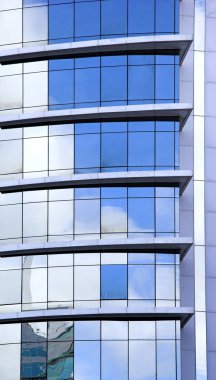 Picture of a Futuristic glass building with reflections clipart