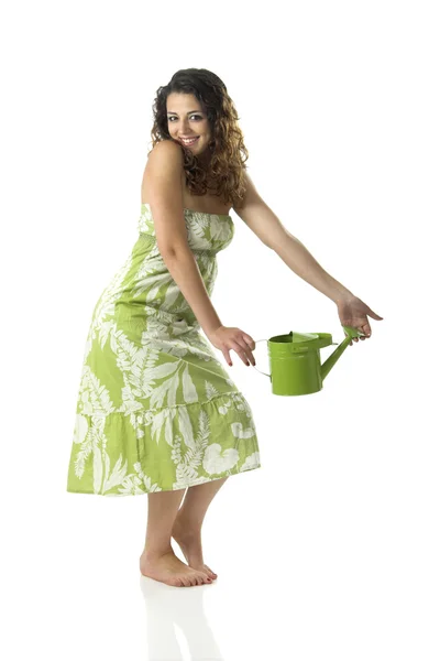 一个漂亮的年轻女子拿着水壶摆姿势的画像 — 图库照片