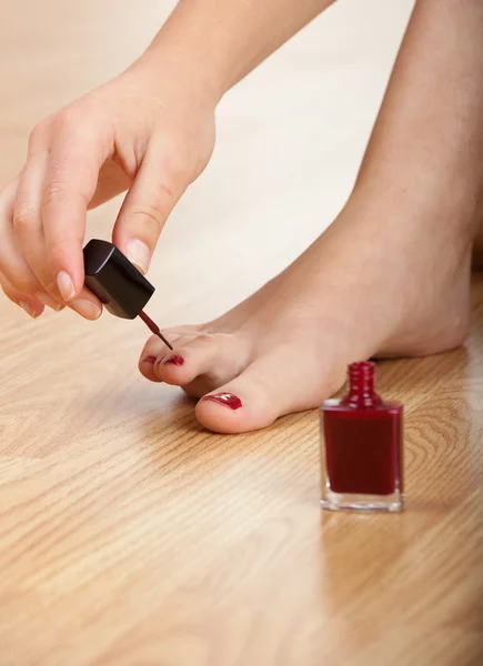 Woman Applying Red Nail Polish Isolated Herself — Stock Fotó