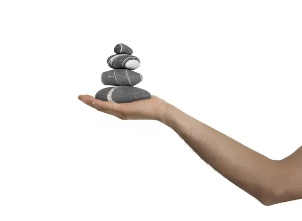 一个男人手上的平衡的石头 — 图库照片