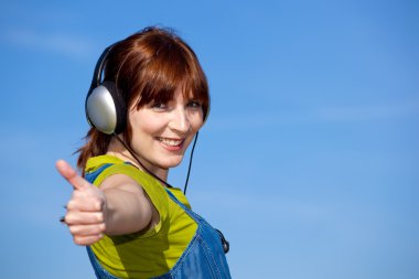 Happy woman listen music clipart